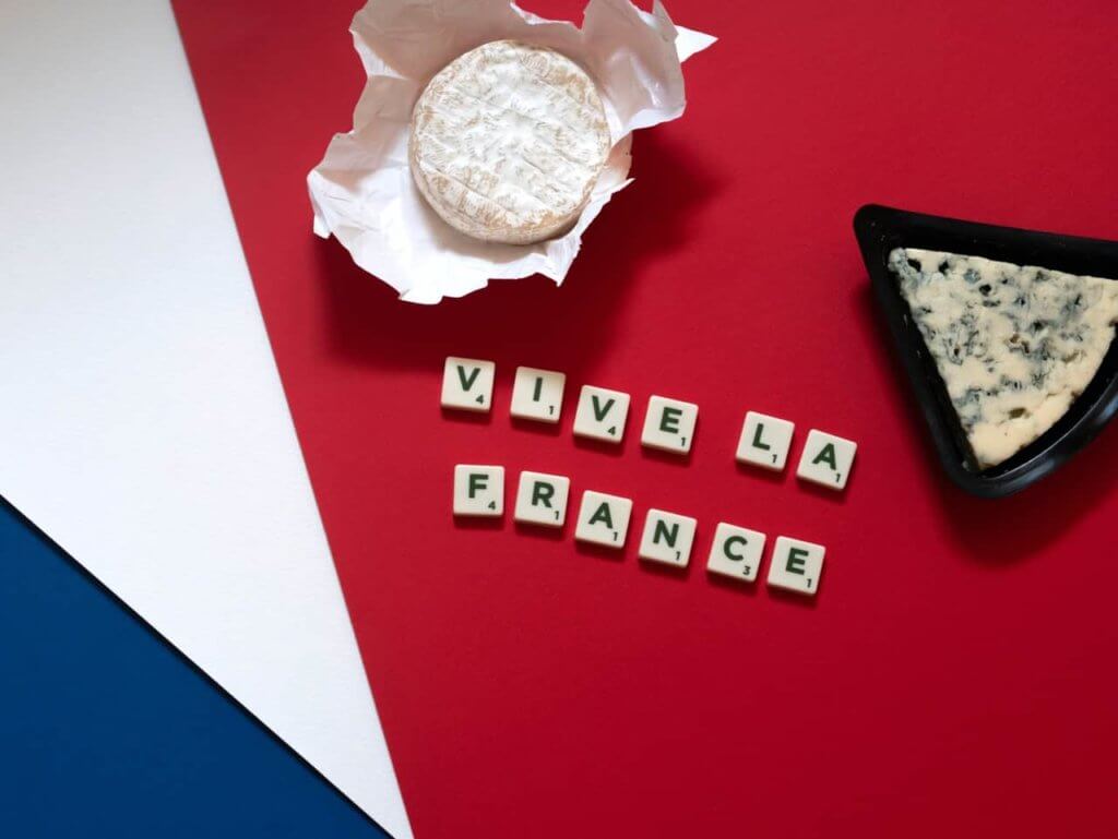 A pastry sits above a set of Scrabble-like tiles that spell VIVE LA FRANCE