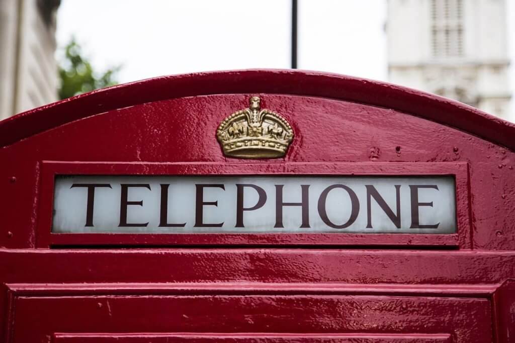 A red telephone booth with a crown logo