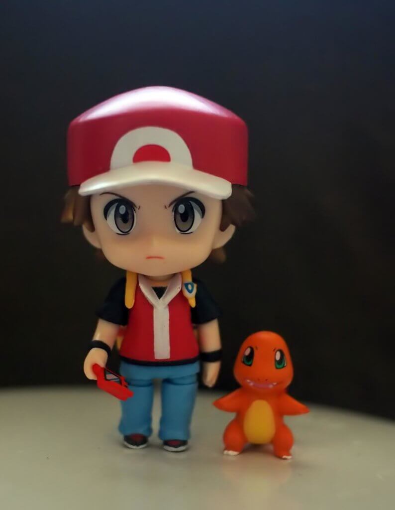 A Pokemon trainer miniature with their Charmander