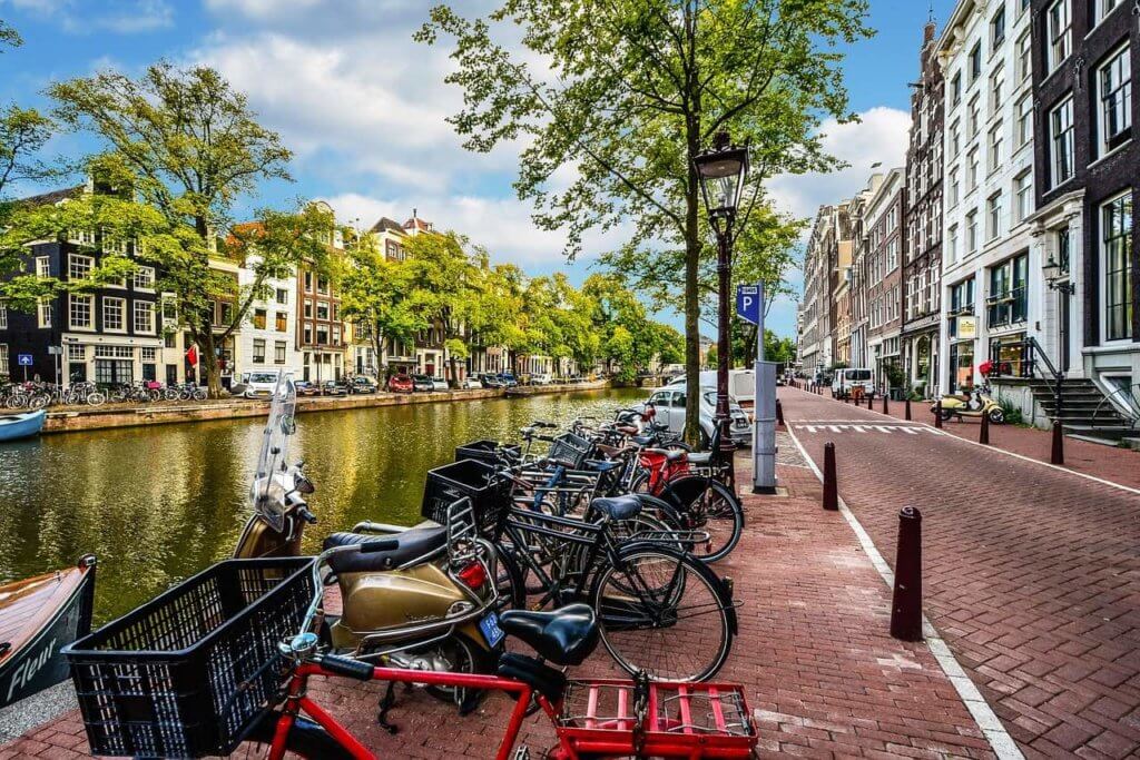 A line of parked bikes along a Dutch canal