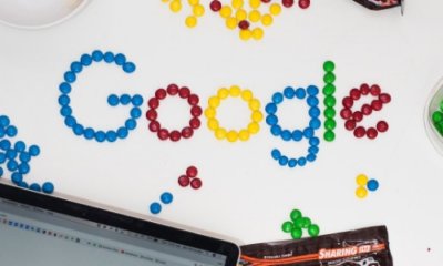 Google logo made from small colored pins on a white background