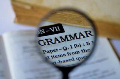 A magnifying glass over the word "grammar"