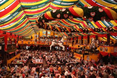 A mass of people revel inside an Oktoberfest tent