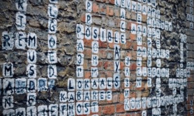word-filled crossword drawn over a brick wall
